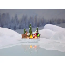 Père Noël et ses rennes au coin du feu lumineux village